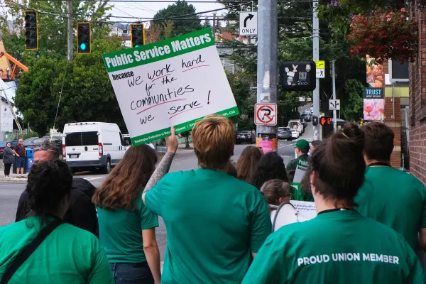 WFSE members protesting. One sign says, "We work hard for the communities we serve!"