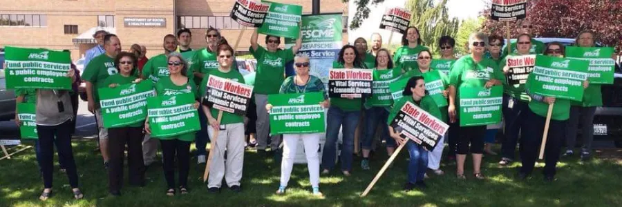 Local 1326 members wearing green holding signs