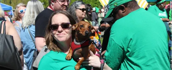 Photo of woman in WFSE shirt holding a dog