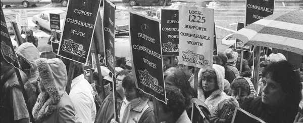 WFSE members with picket signs saying "I Support Comparable Worth"