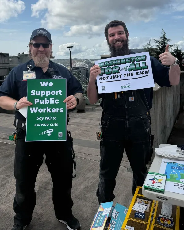 members holding signs Washington For All Not Just the Rich at Harborview Medical Center