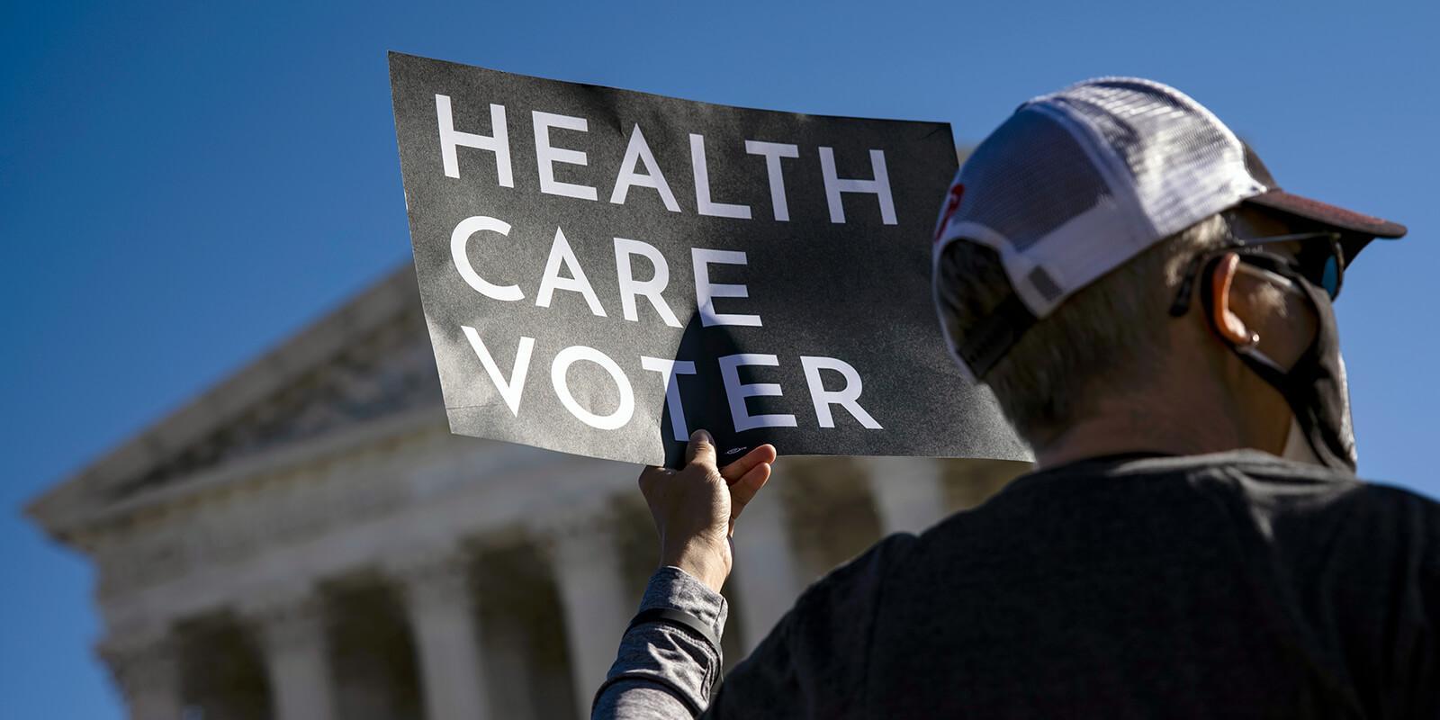 Health care voter holding up a sign